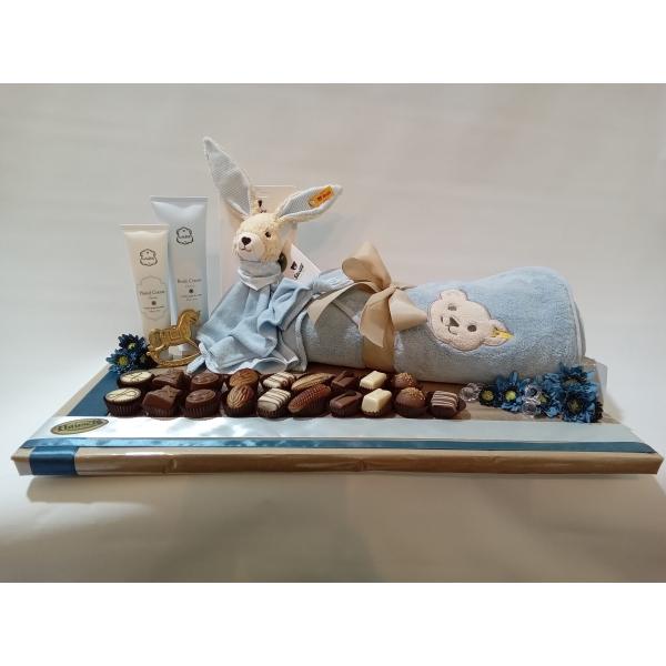 Steiff quality set- including a towel and bavette a hand cream & a body cream from Laline arranged with 19 Hauser pralines.