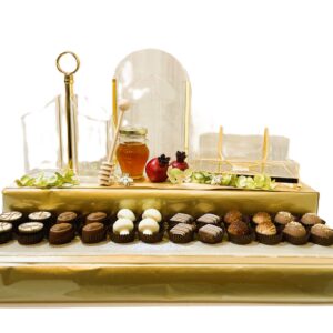 Lucite napkin holder, paper cup holder, cutlery holder on 26 pc. choc praline platform with honey & pom.